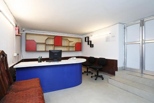 an office with a desk with a computer and two chairs at Hotel O Jalan Lake View Near Mani Square in Tangra