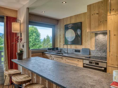 une cuisine avec un grand comptoir et une grande fenêtre dans l'établissement Appartement Confort 3 chambres avec Wifi et Garage - Megève Centre - FR-1-453-100, à Megève