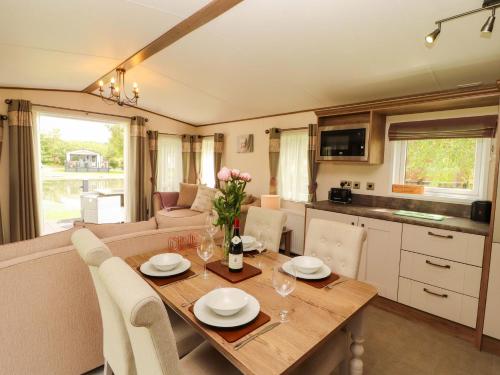 a kitchen and dining room with a table and chairs at 22 Yealand in Carnforth