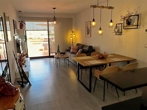 a living room with a table and chairs and a couch at Apartamento acogedor a 200m de la playa con jardín comunitario - ES-376-10 in Pulpí