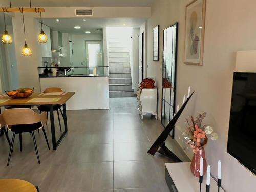 a kitchen and living room with a table and a dining room at Apartamento acogedor a 200m de la playa con jardín comunitario - ES-376-10 in Pulpí