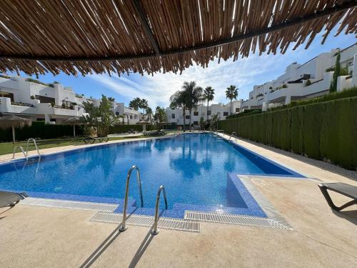 a large blue swimming pool in a resort at Apartamento acogedor a 200m de la playa con jardín comunitario - ES-376-10 in Pulpí