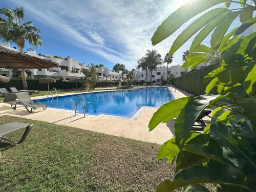 a swimming pool in a yard next to a yard sidx sidx at Apartamento acogedor a 200m de la playa con jardín comunitario - ES-376-10 in Pulpí
