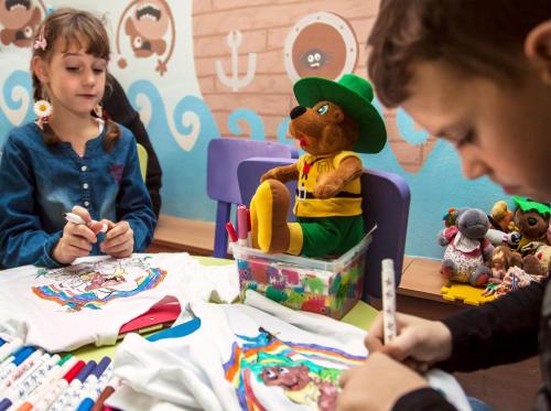 two children sitting at a table playing with toys at Landal Marina Lipno in Lipno nad Vltavou
