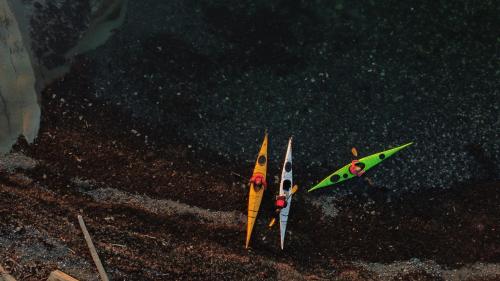 two kayaks are sitting on the beach at Cokely Cove Guesthouse - Oceanside Villa in Denman Island