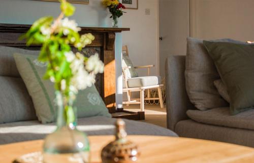 a vase of flowers on a table in a living room at Creag Dubh in Camastianavaig