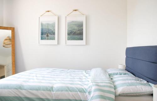 a bedroom with a bed and two pictures on the wall at Creag Dubh in Camastianavaig