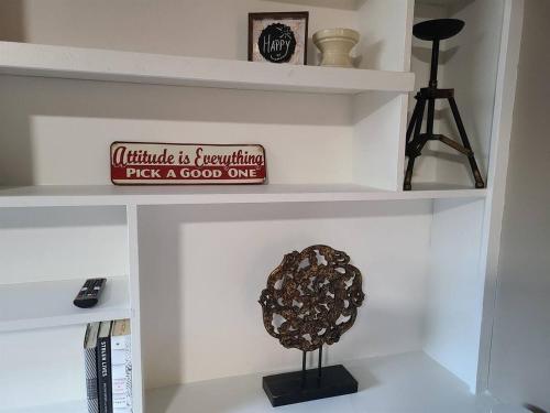 a white shelf with a sculpture on it at No Cleaning Fee BYU Creamery WD 65 TV King in Provo