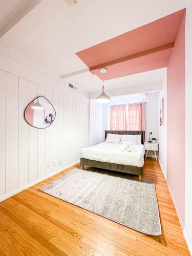 a white bedroom with a bed and a mirror at 6BR Pool Escape for Friends and Family - LOU1 - BUR in Burbank