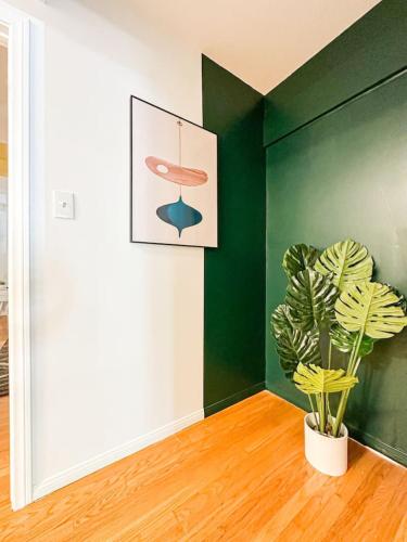 a plant in a room with a green wall at 6BR Pool Escape for Friends and Family - LOU1 - BUR in Burbank