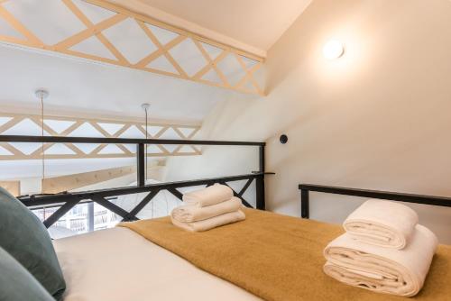 a room with a bed with towels on it at Maison Delage in Courbevoie