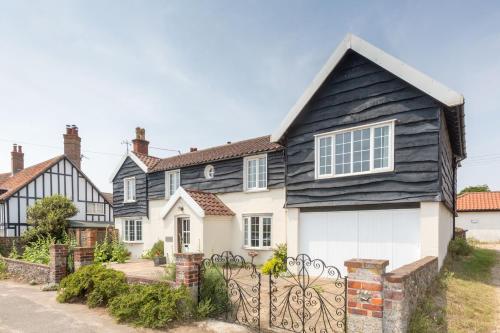 a house with a black and white house at Sea View, Thorpeness in Thorpeness