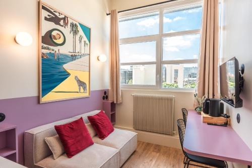 a living room with a couch and a table at Maison Delage in Courbevoie