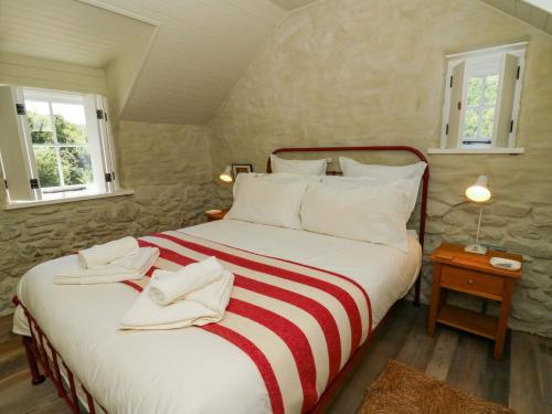 a bedroom with a bed with two towels on it at Dolwylan Barn in Llandysul