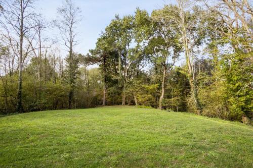 a large green field with trees in the background at La Maison Boisée - Welkeys in Orx