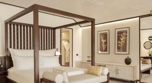 una camera con letto a baldacchino e cuscini bianchi di Carlisle Bay a Old Road