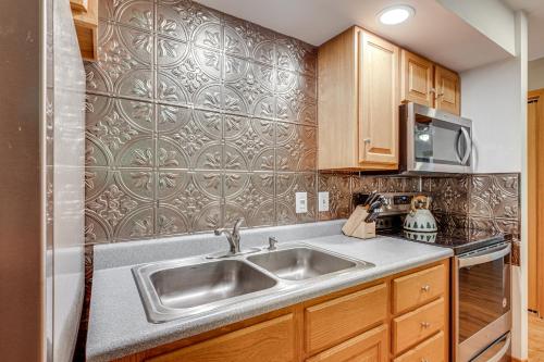 a kitchen with a sink and a microwave at 3 Mi to Gunstock Mountain Resort Gilford Getaway in Gilford