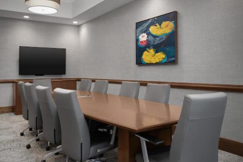 a conference room with a wooden table and chairs at Hampton Inn and Suites by Hilton Vero Beach-Downtown in Vero Beach