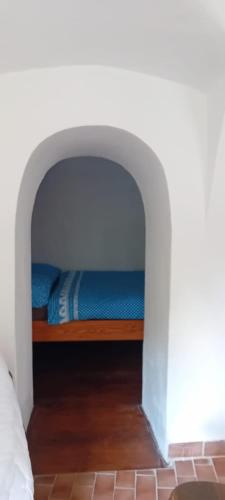 a bedroom with a bed in a white room at Chalupa Vagner, Pernek in Horní Planá