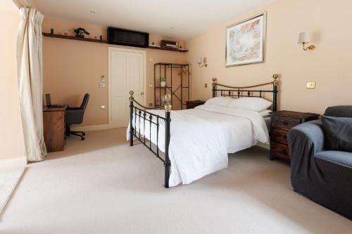 a bedroom with a bed and a chair at Studio Sleeps 2 w HotTub-Garden-PetsOK-Parking in Cromer