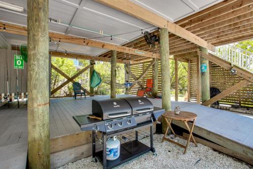 an outdoor patio with a grill and a table at Little Gasparilla Island Escape with 2 Decks! in Placida