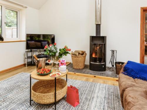a living room with a couch and a fire place at Woodlands in Milverton
