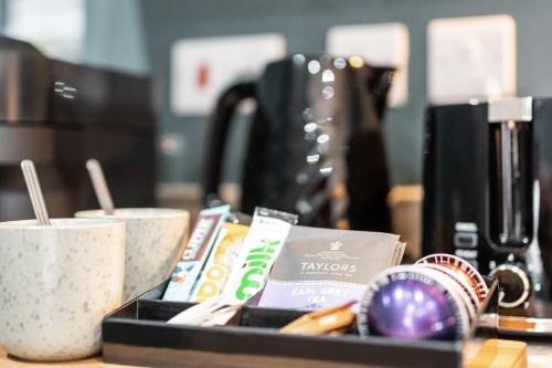 a tray of food and coffee cups on a counter at Athena Suites Leeds LS1 Free Secure Parking! in Leeds