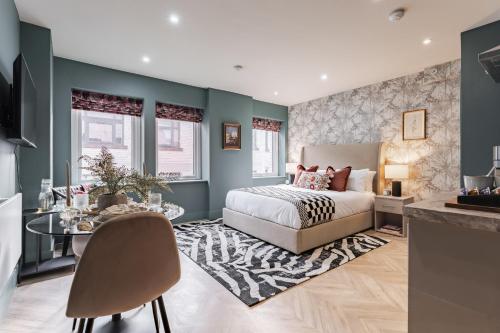 a bedroom with a bed and a table at Athena Suites Leeds LS1 Free Secure Parking! in Leeds