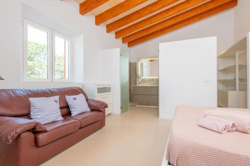 a living room with a couch and a bed at El Paraiso (Porto Cristo) in Porto Cristo