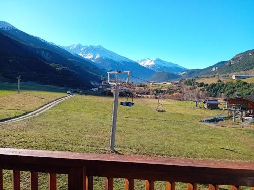 a view of a field with mountains in the background at Balcons B 037 - PARC NAT VANOISE appart 6 pers in Val Cenis
