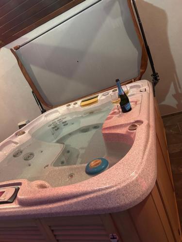 a pink bath tub with a bottle of wine in it at Somló Éden in Somlószőlős