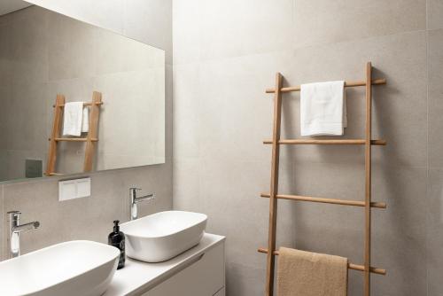 a bathroom with a sink and a mirror at Outsite Private Villa with Infinity Pool and Ocean View in Ericeira