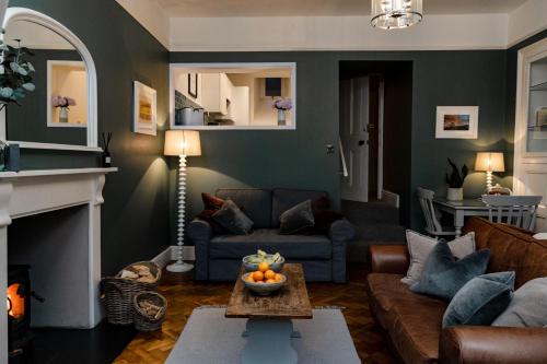 a living room with a couch and a table at Pendle View Apartment in Settle