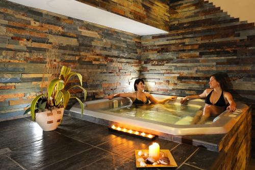 two women sitting in a hot tub in a room at Hotel Life in Rimini