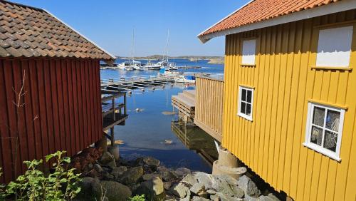 a couple of buildings next to a harbor with boats at Spacious holiday home near Halleviksstrand, perfect for families in Ellös