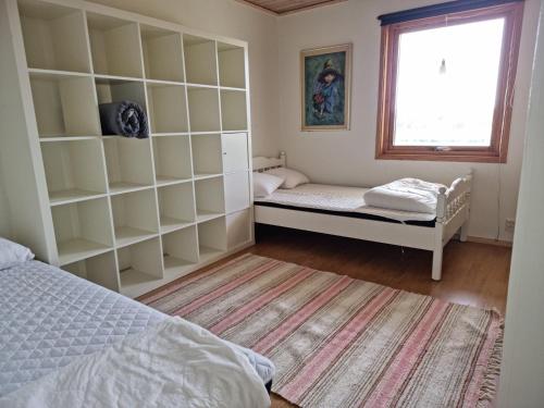 a bedroom with two beds and a window at Spacious holiday home near Halleviksstrand, perfect for families in Ellös