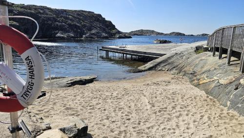 a beach with a pier next to the water at Spacious holiday home near Halleviksstrand, perfect for families in Ellös