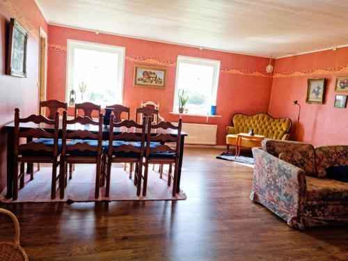 a dining room with a table and a couch at Spacious holiday home near Halleviksstrand, perfect for families in Ellös