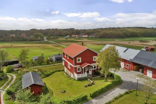 an aerial view of a house and a barn at Spacious holiday home near Halleviksstrand, perfect for families in Ellös