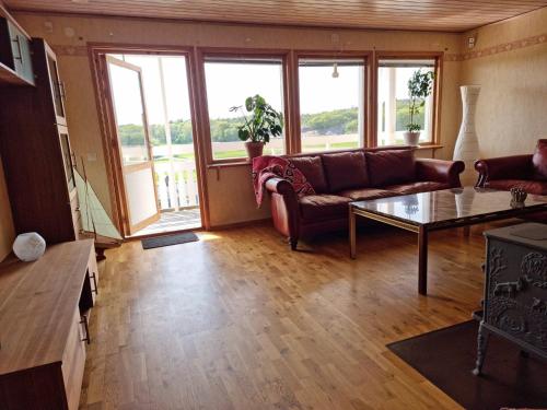 a living room with a couch and a table at Spacious holiday home near Halleviksstrand, perfect for families in Ellös