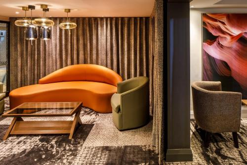 a living room with a couch and a table and chairs at Crowne Plaza Manchester Airport by IHG in Hale