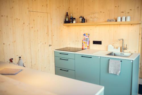 a kitchen with a sink and a counter top at Exklusive Cabins am Rursee inmitten der Natur – mlab relax Eifel in Simmerath