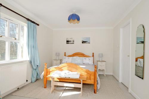 a bedroom with a bed and a window at Finest Retreats - Corrennie School Cottage in Inverurie