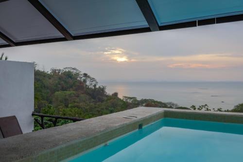 a swimming pool with a view of the ocean at Akua Suites Ocean View in Tarcoles