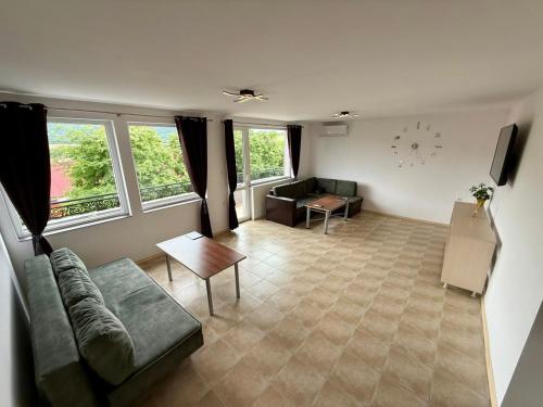 a living room with a couch and a table at Къща за гости Галанти Guest house Galanti in Orchenlar