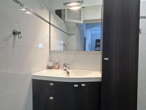 une salle de bain avec un lavabo et un miroir dans l'établissement Appartement 3 pièces avec jardinet proche centre Banyuls - FR-1-225C-39, à Banyuls-sur-Mer