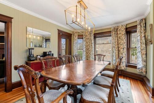 a dining room with a wooden table and chairs at Historic Queen Anne Family Home w Modern Comforts in Harpers Ferry