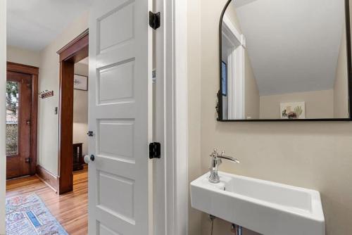 a bathroom with a sink and a mirror at Historic Queen Anne Family Home w Modern Comforts in Harpers Ferry