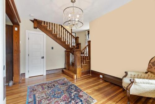 a living room with a staircase and a couch at Historic Queen Anne Family Home w Modern Comforts in Harpers Ferry