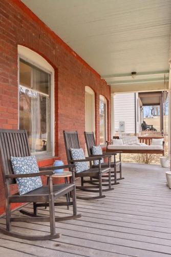 a group of benches sitting on a porch at Historic Queen Anne Family Home w Modern Comforts in Harpers Ferry